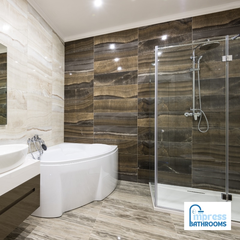 Luxury bathroom renovations featuring a corner bathtub, glass shower, and elegant marble tiles for a stylish upgrade.
