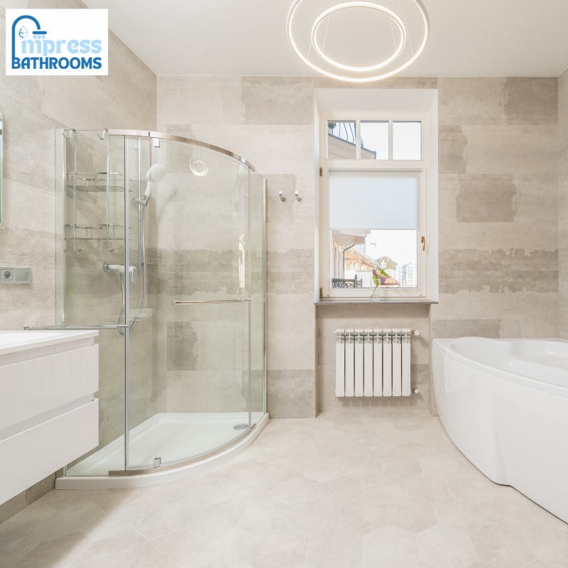 Modern bathroom renovations in Tumbi Umbi with a glass shower, freestanding bath, sleek white vanity, and elegant lighting, filled with natural light.