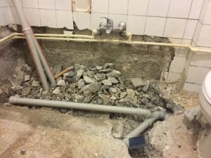 Plumbing repairs and wall damage are hidden costs that raise the total cost to renovate bathroom spaces significantly